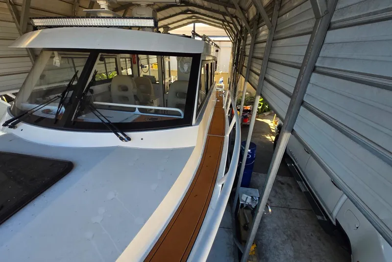 Slide: The Image of 2025 Custom Boat 34 in covered storage, showcasing sleek design and modern features. - 9