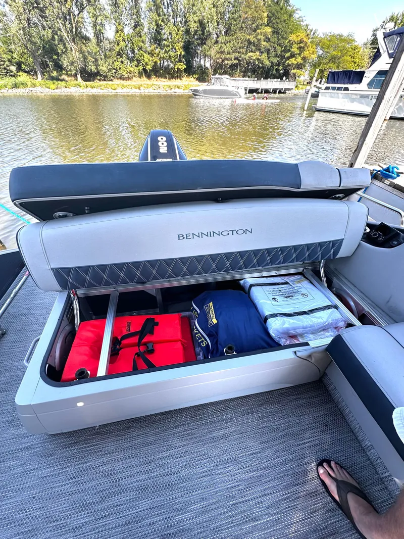 Slide: The Image of Bennington 25 QSB 2021 boat with open storage by the lake. - 5