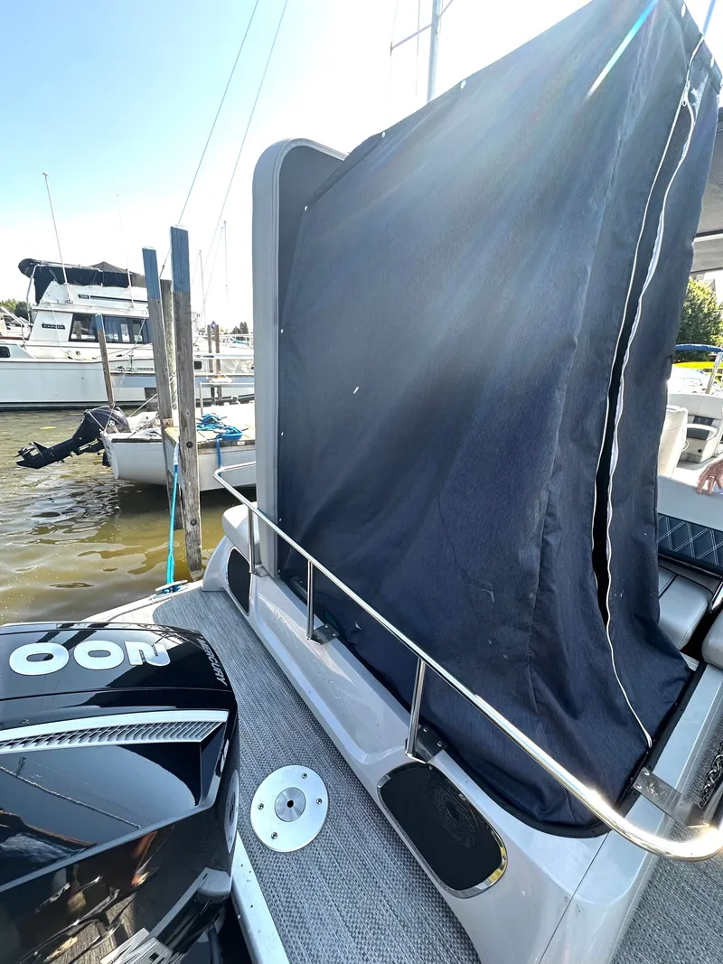 Slide: The Image of 2021 Bennington 25 QSB boat at dock with cover. - 9