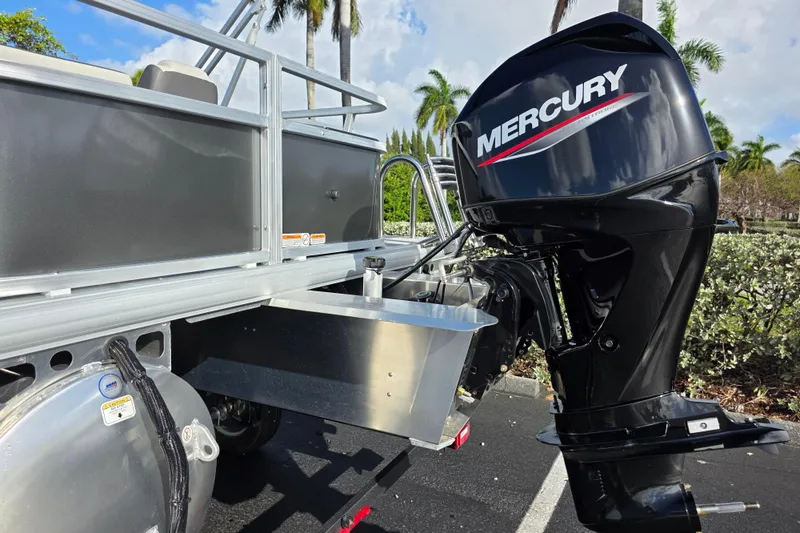 Slide: The Image of 2026 Sun Tracker Bass Buggy 16 XL Select with Mercury outboard motor in a sunny setting. - 11