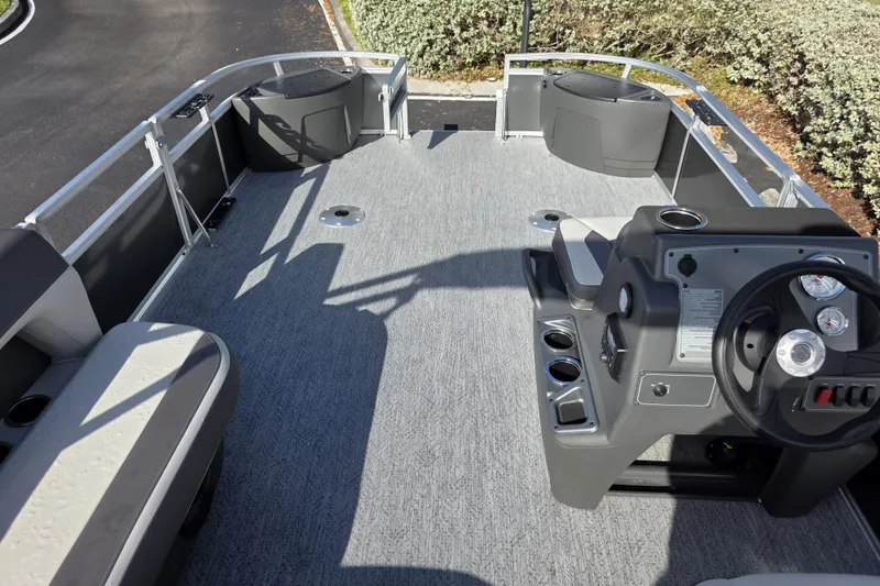 Slide: The Image of 2026 Sun Tracker Bass Buggy 16 XL Select pontoon boat interior with steering console. - 5
