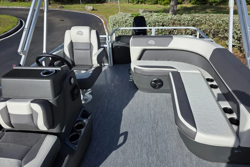 Slide: The Image of 2026 Sun Tracker Bass Buggy 16 XL Select pontoon boat interior with seating and steering console. - 6