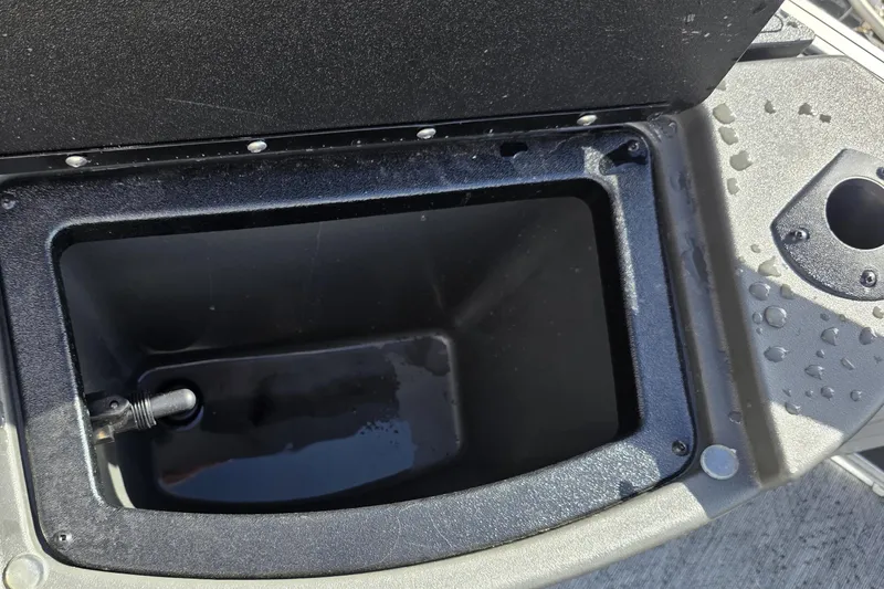 Slide: The Image of Livewell compartment on 2026 Sun Tracker Bass Buggy 16 XL Select boat, partially filled with water. - 8