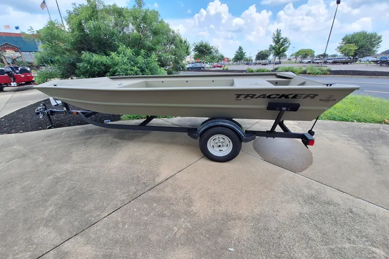 The Image of 2026 Tracker Grizzly 1754 Utility boat on trailer, parked outdoors. - 0