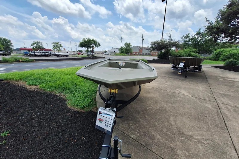 Slide: The Image of 2026 Tracker Grizzly 1754 Utility boat displayed outdoors on a trailer. - 3