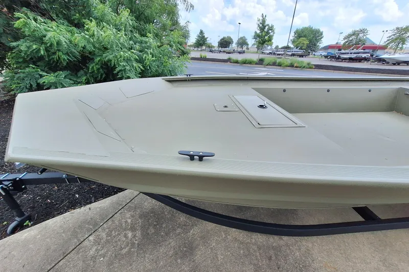 Slide: The Image of 2026 Tracker Grizzly 1754 Utility boat on trailer, parked outdoors. - 2