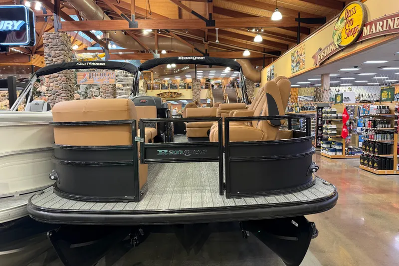 Slide: The Image of 2026 Ranger 223FC pontoon boat displayed in a marine store showroom. - 2