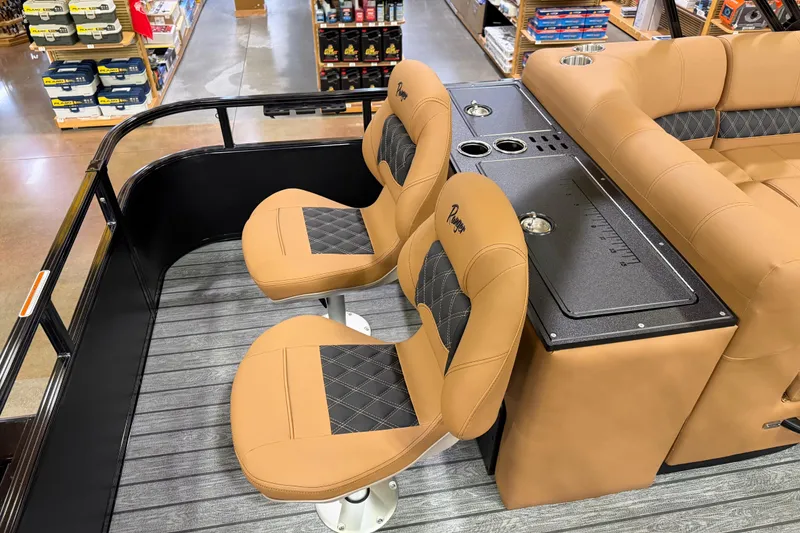 Slide: The Image of 2026 Ranger 223FC boat interior with tan and black seating, cup holders, and storage. - 5
