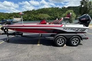 The Image of 2026 Nitro Z19 XL Pro boat on trailer, parked near a scenic lake. - 0