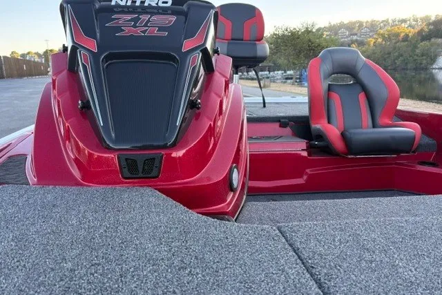 Slide: The Image of 2026 Nitro Z19 XL Pro boat with red and black seating, docked near a waterfront. - 45