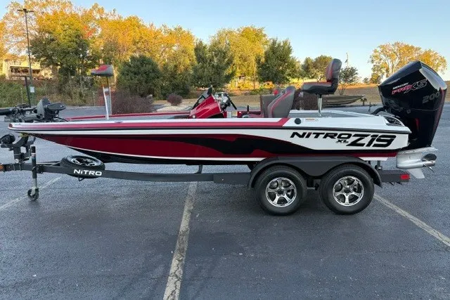 Slide: The Image of 2026 Nitro Z19 XL Pro boat on trailer, parked outdoors with trees in background. - 3
