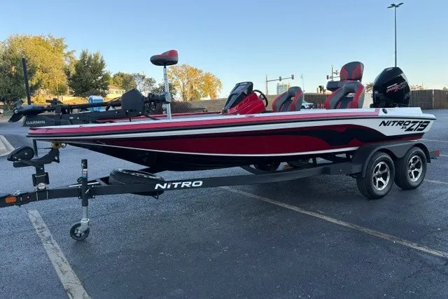 Slide: The Image of 2026 Nitro Z19 XL Pro boat on trailer in parking lot, red and white design. - 5