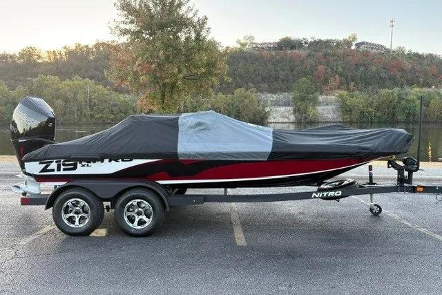 Slide: The Image of 2026 Nitro Z19 XL Pro boat covered on trailer, parked near scenic riverbank. - 11