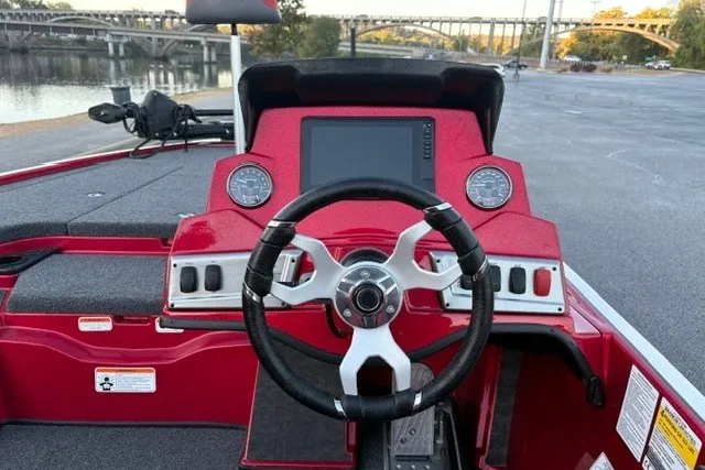 Slide: The Image of 2026 Nitro Z19 XL Pro boat dashboard with steering wheel and digital display, near a waterfront. - 48
