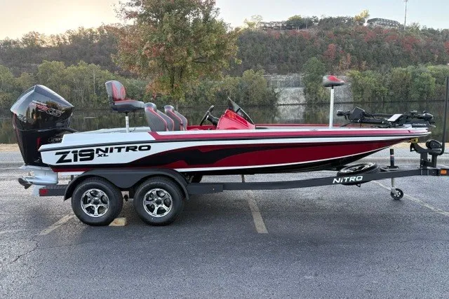 The Image of 2026 Nitro Z19 XL Pro boat on trailer, parked near scenic river backdrop. - 0