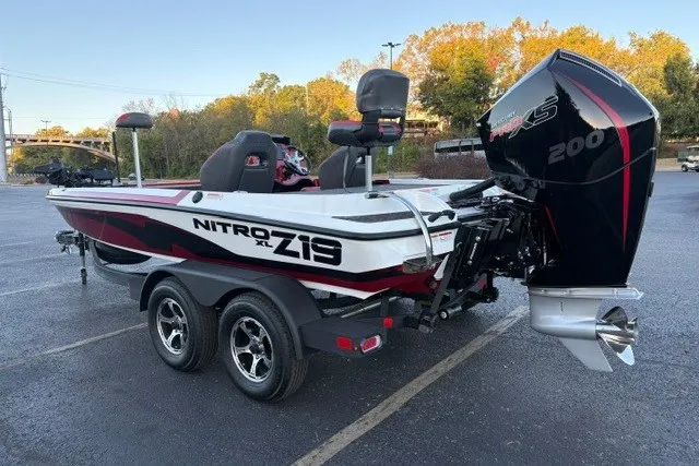 Slide: The Image of 2026 Nitro Z19 XL Pro boat with powerful engine, parked on a trailer in a scenic area. - 12