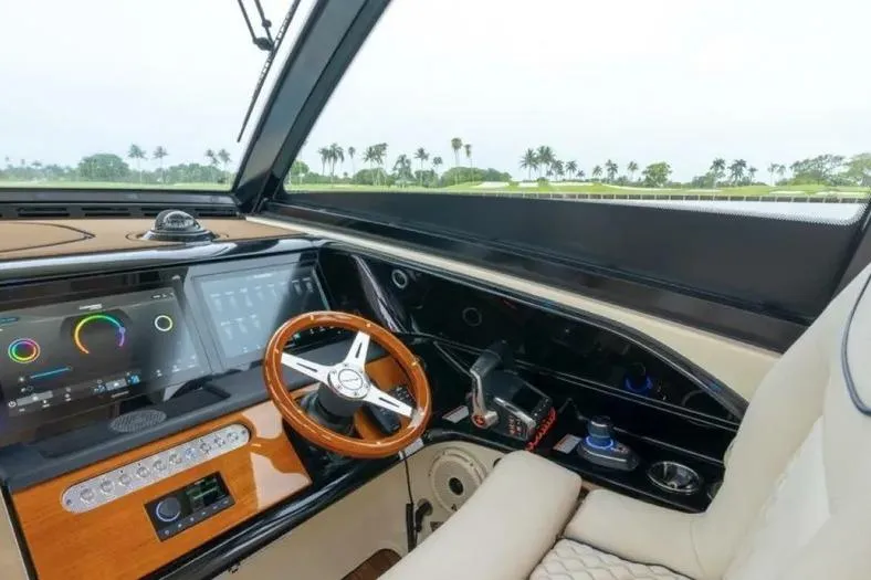 Slide: The Image of 2023 Chris-Craft Calypso 35 helm with modern controls and wooden steering wheel. - 11