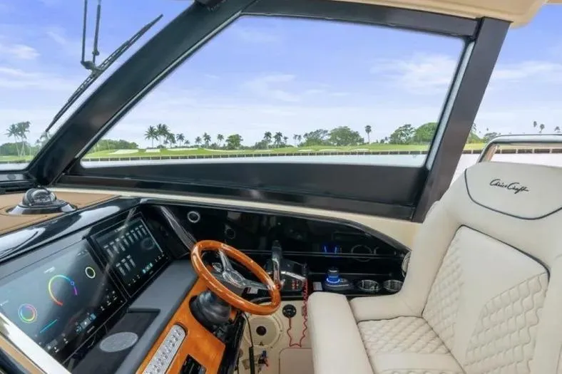 Slide: The Image of Interior of 2023 Chris-Craft Calypso 35 boat with luxury seating and modern dashboard. - 13