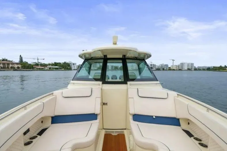 Slide: The Image of 2023 Chris-Craft Calypso 35 boat interior with waterfront view, featuring luxurious seating. - 17