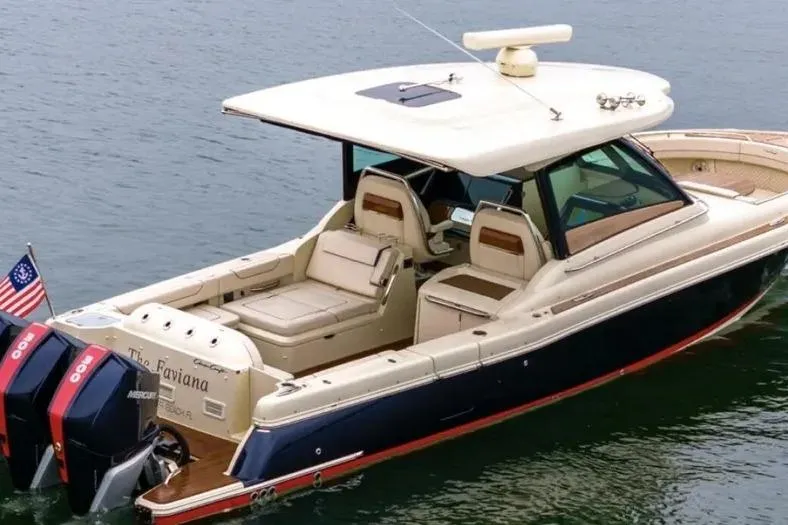 Slide: The Image of 2023 Chris-Craft Calypso 35 boat with dual Mercury engines on water. - 2