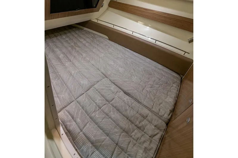 Slide: The Image of Manufacturer Provided Image: 2023 Chris-Craft Calypso 35 cabin bed with patterned bedding. - 22