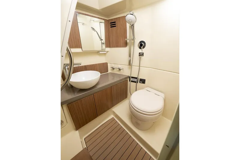 Slide: The Image of Manufacturer Provided Image: 2023 Chris-Craft Calypso 35 bathroom with modern fixtures and wooden cabinetry. - 23