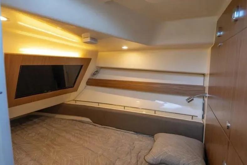 Slide: The Image of 2023 Chris-Craft Calypso 35 cabin interior with cozy bed and modern lighting. - 26