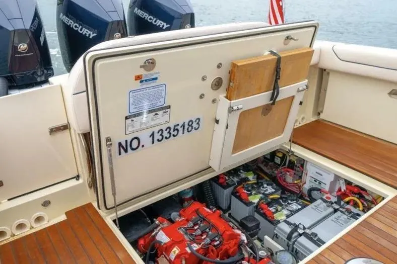 Slide: The Image of 2023 Chris-Craft Calypso 35 boat engine compartment with Mercury outboards and equipment. - 27
