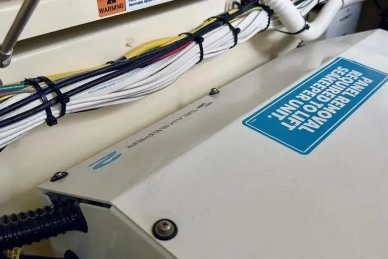 Slide: The Image of 2023 Chris-Craft Calypso 35 engine compartment with wiring and panel removal instructions. - 28