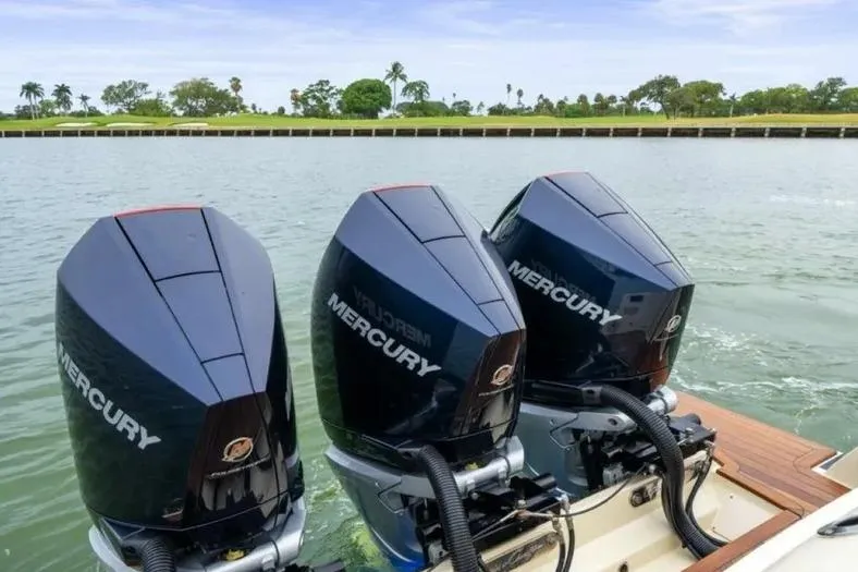 Slide: The Image of 2023 Chris-Craft Calypso 35 with triple Mercury outboard engines on a calm waterway. - 29