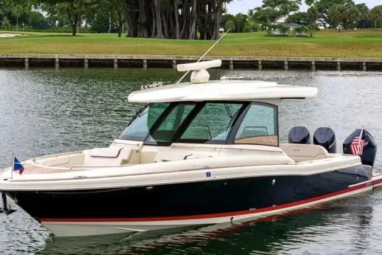 Slide: The Image of 2023 Chris-Craft Calypso 35 boat on calm water, showcasing sleek design and luxury features. - 5