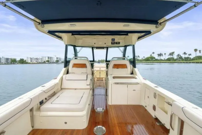 Slide: The Image of 2023 Chris-Craft Calypso 35 boat interior with luxurious seating and wooden flooring. - 8