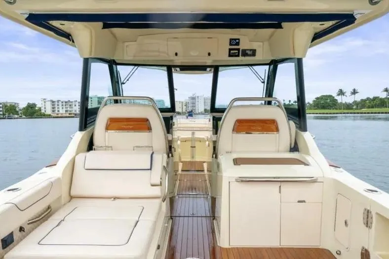 Slide: The Image of 2023 Chris-Craft Calypso 35 interior with luxurious seating and scenic water view. - 9