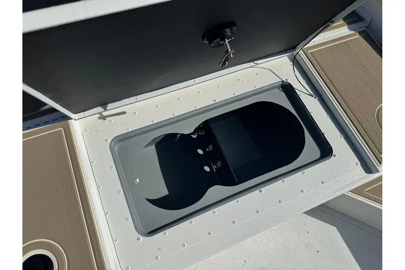 Slide: The Image of Open storage compartment on 2026 G3 Bay 17 boat deck with key lock. - 15