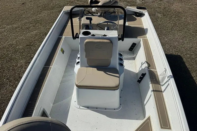 Slide: The Image of 2026 G3 Bay 17 boat interior with beige seating and steering console. - 19