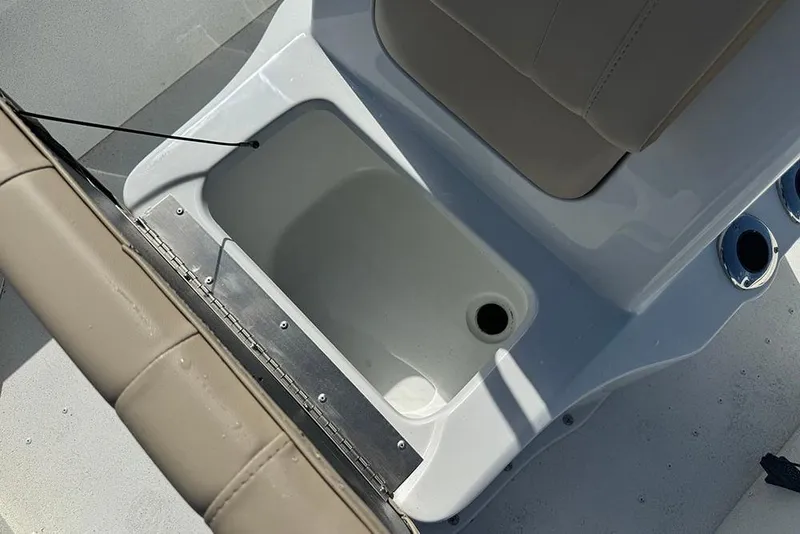 Slide: The Image of 2026 G3 Bay 17 boat interior with storage compartment and beige seating. - 21