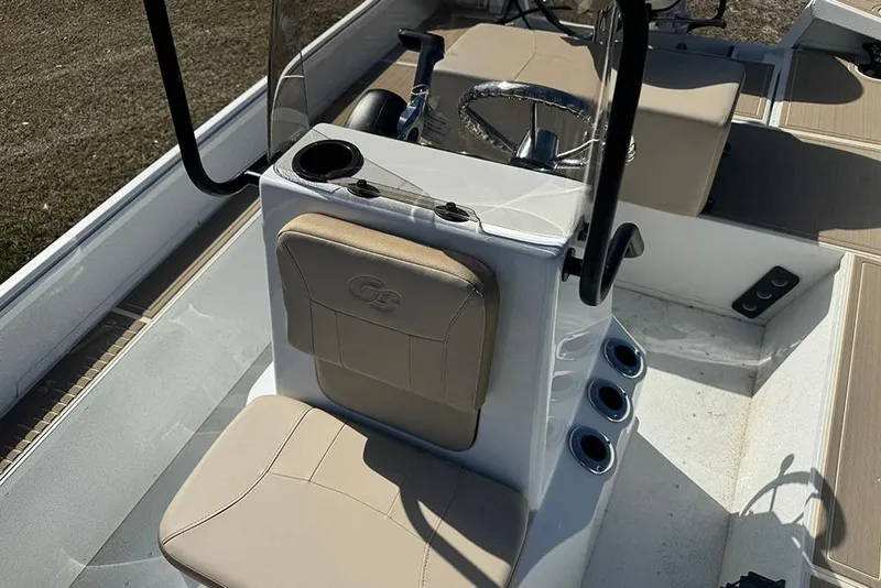 Slide: The Image of 2026 G3 Bay 17 boat interior with beige seating and steering console. - 22