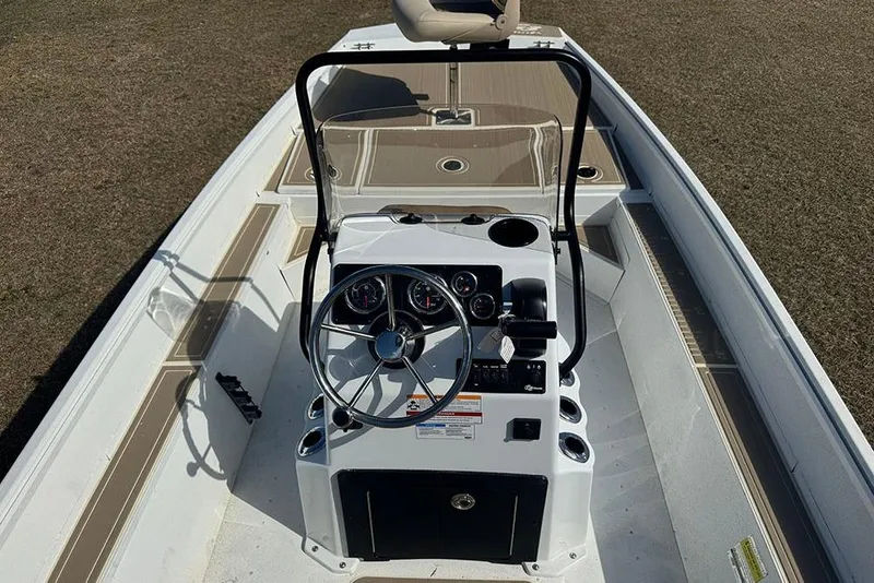 Slide: The Image of 2026 G3 Bay 17 boat console with steering wheel and gauges, on dry land. - 25