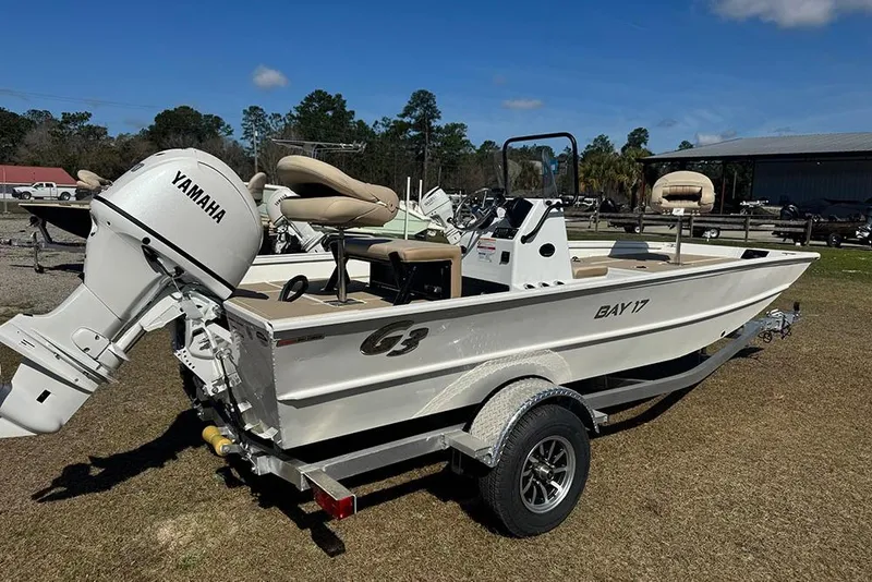 Slide: The Image of 2026 G3 Bay 17 boat with Yamaha engine on trailer, parked outdoors. - 3