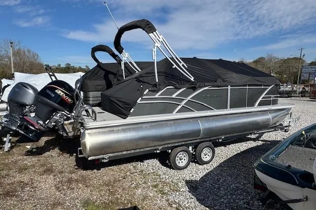 The Image of 2026 Sylvan 822 Mirage Cruise pontoon boat on trailer, covered and parked outdoors. - 1