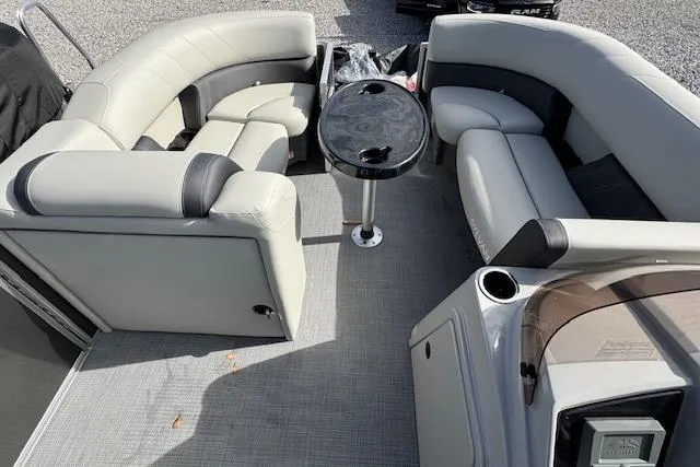Slide: The Image of 2026 Sylvan 822 Mirage Cruise boat interior with plush seating and central table. - 10