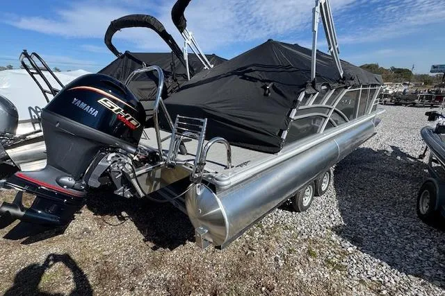 Slide: The Image of 2026 Sylvan 822 Mirage Cruise pontoon boat with Yamaha engine on gravel lot. - 3