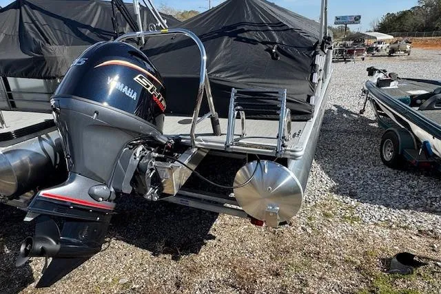 Slide: The Image of 2026 Sylvan 822 Mirage Cruise pontoon boat with Yamaha outboard motor, parked on gravel. - 4