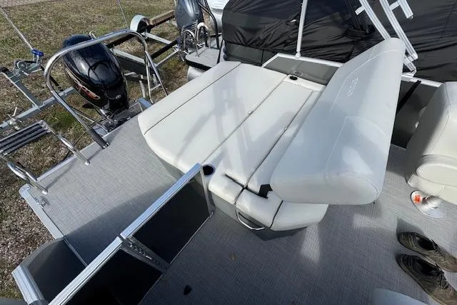 Slide: The Image of 2026 Sylvan 822 Mirage Cruise boat interior with seating and motor. - 5