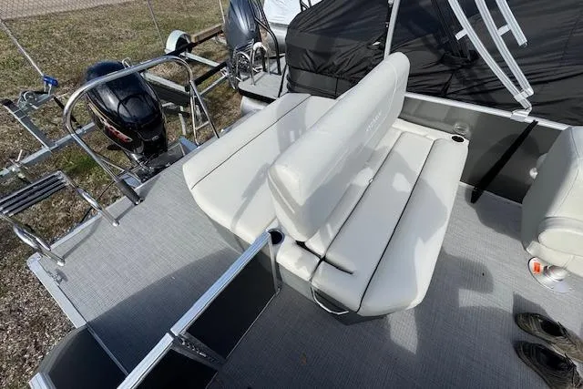 Slide: The Image of 2026 Sylvan 822 Mirage Cruise boat interior with white seating and motor. - 6