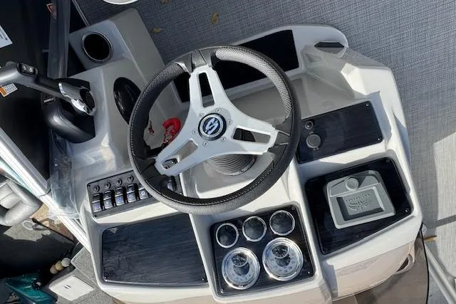 Slide: The Image of 2026 Sylvan 822 Mirage Cruise boat dashboard with steering wheel and control panel. - 9
