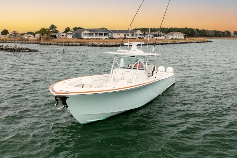 Slide: The Image of 2023 Valhalla Boatworks V-41 cruising on calm waters at sunset. - 2