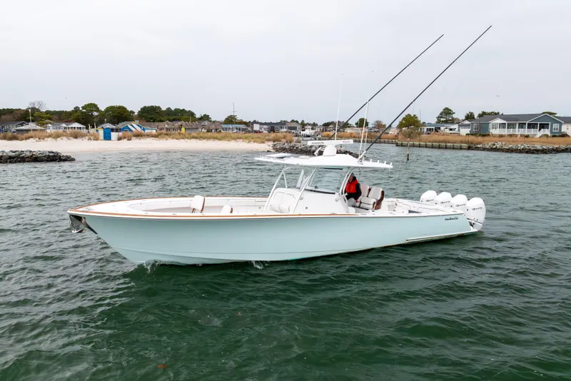 Slide: The Image of 2023 Valhalla Boatworks V-41 cruising near a sandy shoreline with fishing rods. - 7