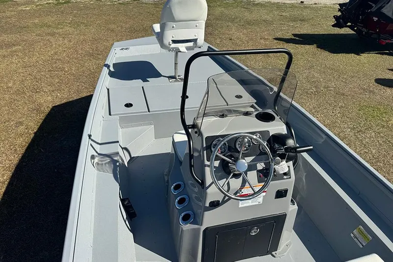 Slide: The Image of 2026 G3 Bay 17 boat interior with steering console and seating on display. - 11