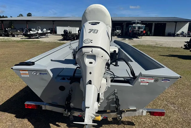 Slide: The Image of 2026 G3 Bay 17 boat with 70 HP motor, parked outdoors near storage facility. - 4
